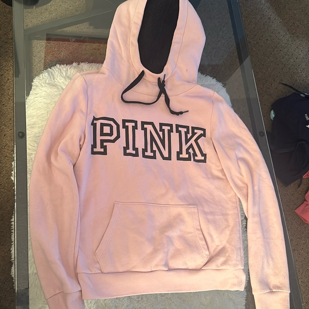 Pale pink, PINK hoodie. Fuzzy black inside the hood.